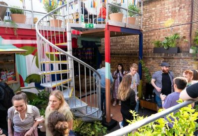 Exterior courtyard with a silver spiral staircase and terrace seating.