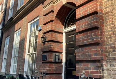 Exterior brick facade and arched entrance of 2 Catherine Place, London.