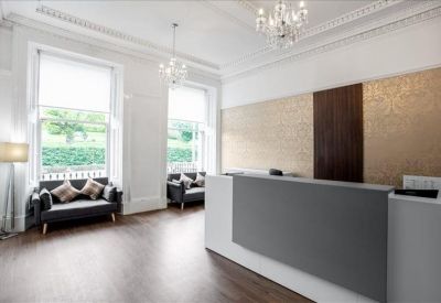 Elegant reception area with a grey front desk and ornate chandeliers.