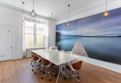 Meeting room with a scenic lake mural and warm wood flooring.