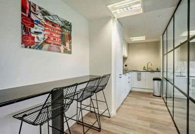 Kitchenette area with a breakfast bar, wire bar stools, and modern cabinetry.