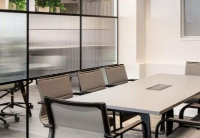 A professional meeting room at 24-28 Oval Road with frosted glass partitions and modern grey chairs.