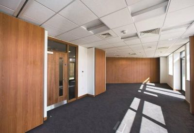 Private meeting room featuring wood-paneled walls and suspended ceilings.