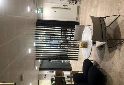 Modern lounge area with a marble cafe table and black circular seating.