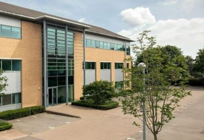Exterior view of the brick and glass office building at 2530 Aztec West.