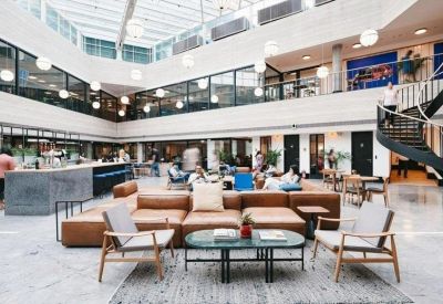 Spacious communal area with a large sofa and natural lighting.
