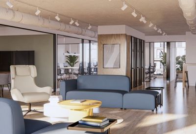 Spacious lounge at 268, Paseo de la Castellana, Chamartín, Madrid with blue sofas, a yellow table, and wood accents.