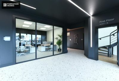 Sleek reception area with white terrazzo floors and a glass-walled office suite.
