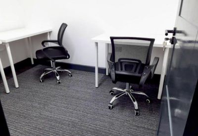 Internal office suite with grey carpeting and contemporary workstations.