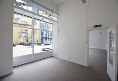 Private office suite featuring a glass partition and view of the courtyard.
