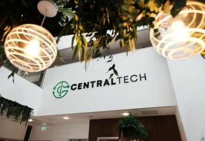 Branded reception area featuring hanging greenery and warm lighting.