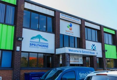 Close-up of the building entrance showing company signage for the Spelthorne Business Hub.