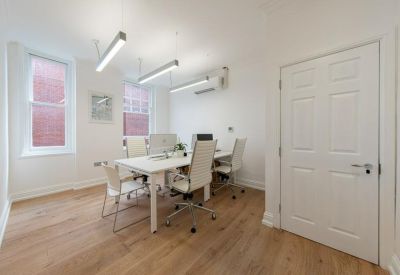Bright private office suite with white desks and ergonomic chairs.