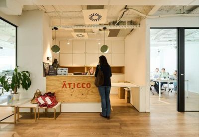 Reception desk in a modern lobby with wooden accents.