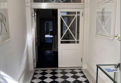 Entryway featuring a decorative fanlight window and checkerboard floor tiles.