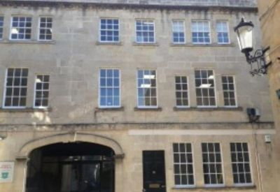 Street level view of a traditional stone-fronted office building.