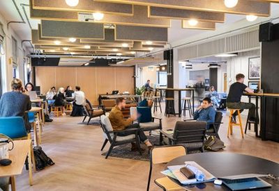 Lounge area with mid-century modern armchairs and wood-slat ceiling.