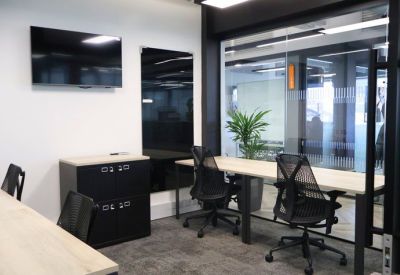 Small meeting room with glazed walls and a monitor.