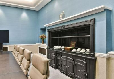 Close-up of a traditional black range stove repurposed as a coffee station in a meeting room.