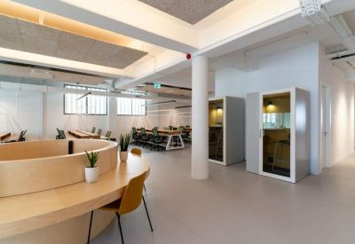 Cozy shared office space featuring individual soundproof phone booths for private calls.