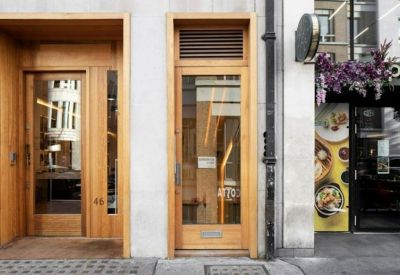 Wooden entrance doors to the building at 46a Great Marlborough Street in London.