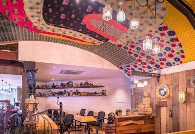 Wood-paneled meeting area with a Buddha statue and a decorative patterned ceiling.