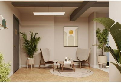 Modern lounge area with stylish armchairs, indoor plants, and a warm wooden floor.