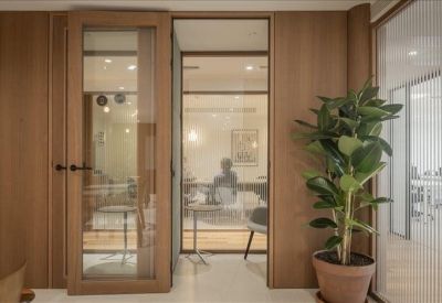 Meeting room with a glass door and wood-paneled walls.