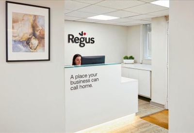 Branded reception area with a white desk and 'A place your business can call home' text.