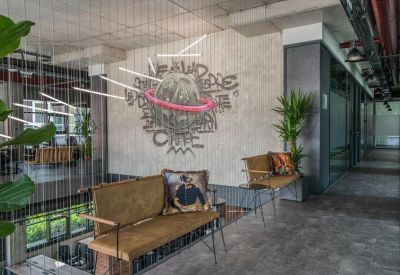 Reception area featuring a creative planetary wall mural and stylish mid-century seating.