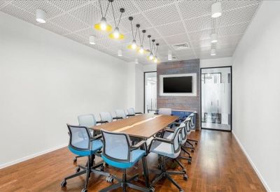 Vibrant breakout area featuring blue cushioned booths and themed wall graphics.