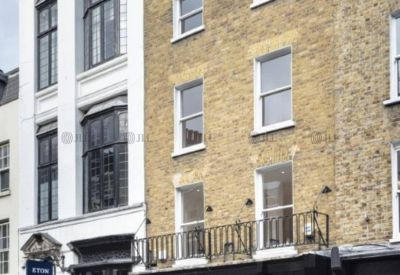Exterior view of the classic brick and white facade building at 54, South Molton Street, London.
