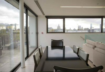 Meeting room featuring a long dark table and panoramic city views towards St Paul's Cathedral.