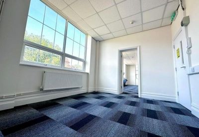 Bright office suite featuring modern drop ceilings and neutral white walls.