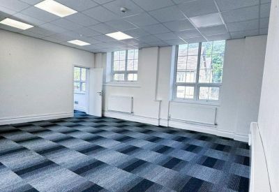 Large empty workspace with multiple windows providing ample natural light.