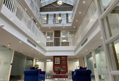 Atrium with high ceilings and blue sofas.