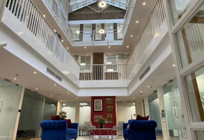 Atrium with high ceilings and blue sofas.