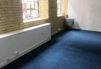 Bright office suite with exposed brick accents and large windows for natural light.