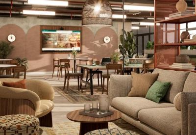 Vibrant coworking lounge with various seating options, patterned ottomans, and decorative shelving.