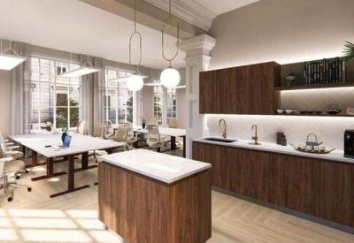 Communal kitchen area with dark wood cabinets and a marble-top island.