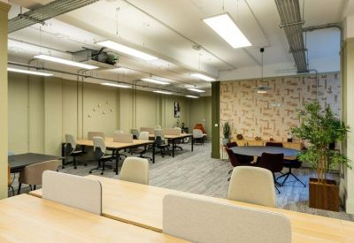 Modern lobby with green walls, a black marble desk, and bold abstract art.