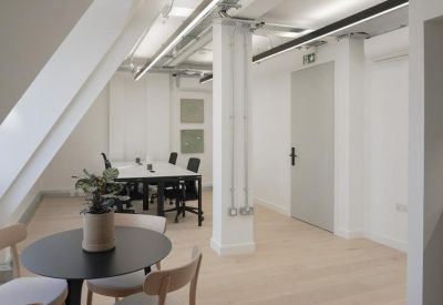 Bright office space with a small round table and minimalist decor.