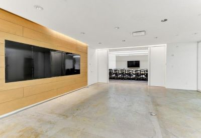 Sleek reception area with wood-paneled feature wall and large digital screen.