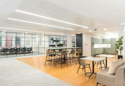 Spacious communal lounge and breakout area with wooden flooring.