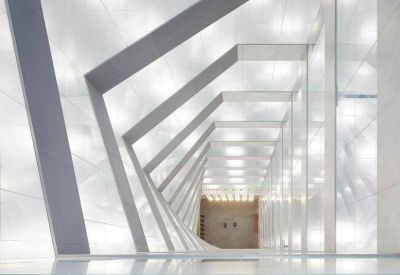 Futuristic white hallway with geometric archways and integrated lighting.