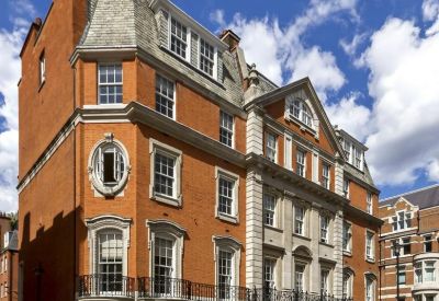 Exterior view of the classic red brick facade and ornate windows at 84 Brook Street.