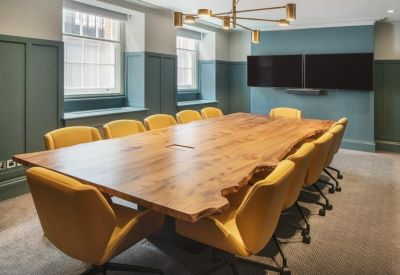 Modern meeting room featuring a live-edge wooden table and vibrant yellow chairs.