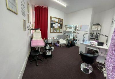 Spacious workstation area featuring a white desk, red curtains, and natural light.