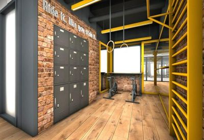 Industrial-style gym area with lockers, brick walls, and exercise bikes.