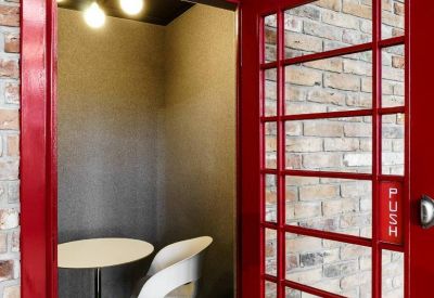 Private meeting pod designed like a classic red British telephone booth.